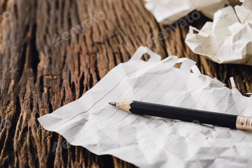 Preview: Close Up Of Pencil With Crumpled Paper On Wooden Background