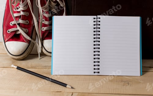 Preview: Book With Sneakers On Wooden Floor