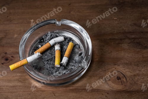 Preview: Cigarettes With Ashtray On Wooden Background
