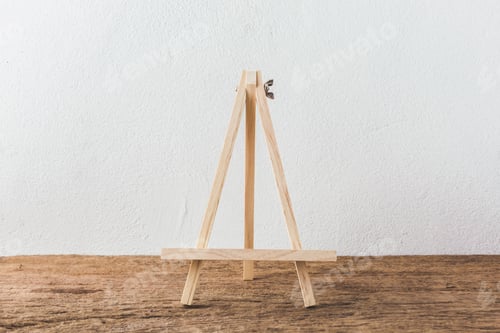 Preview: Wooden Easel On Wooden Table With White Cement Background