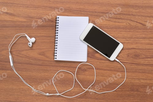 Preview: Smartphone And Notebook On Wooden Table