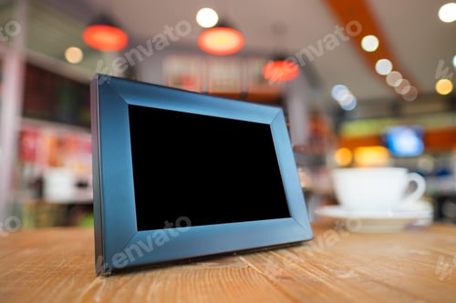 Preview: Black Picture Frame On Wooden Table In In Bar Restaurant Cafe.