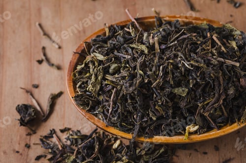 Preview: Dry Leaves Green Tea In Bowl On Wooden Background