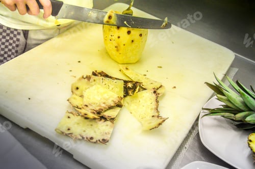 Preview: A Female Cook Peeling A Pineapple In A Restaurant Kirchen