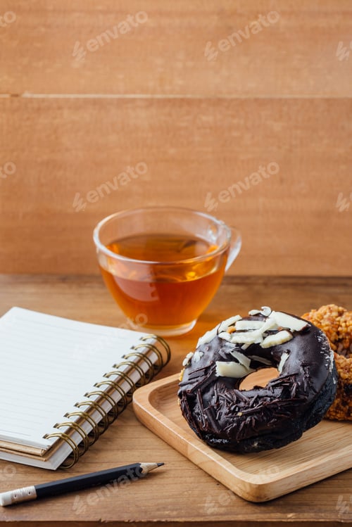 Preview: Donut, Tea, and Notepad on a Wood Table