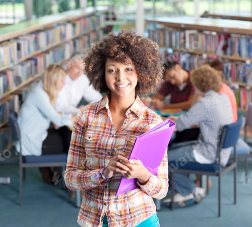 Preview: Female High School Student In Library Holding Folder Smiling At Camera