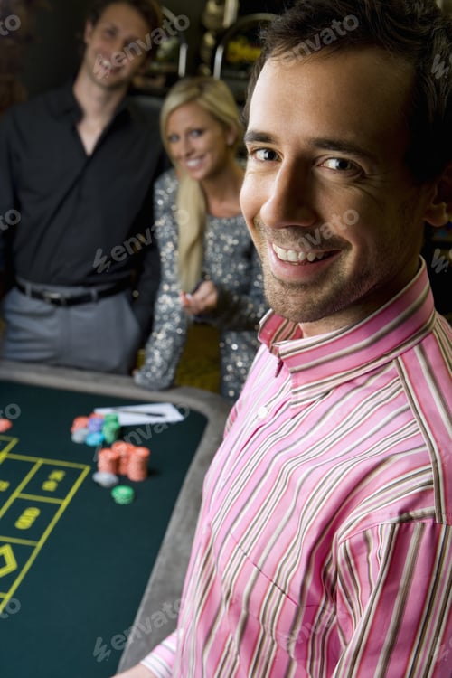 Preview: Young Man By Friends Gambling At Roulette Table, Smiling, Portrait, Close-Up