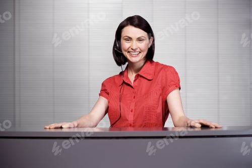 Preview: Office Receptionist In A Red Blouse, Smiling