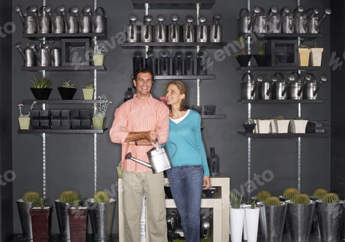 Preview: Couple Shopping In Garden Centre, Man Carrying Watering Can, Indoors, Portrait