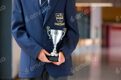 Preview: Detail Of Male Student In School Uniform Holding School Trophy