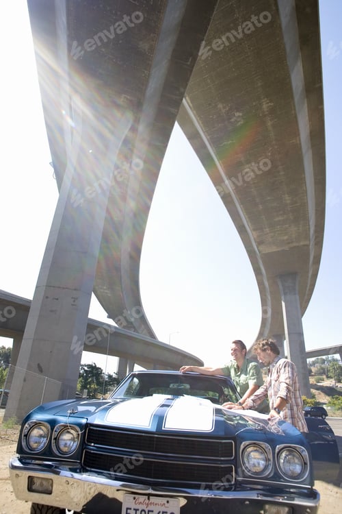 Preview: Two Young Men By Car Beneath Overpass, Low Angle View (Sun Flare)