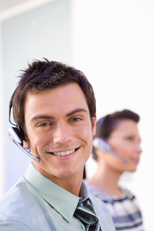 Preview: Businessman In Sales Team Making Phone Call Wearing Headset At Camera