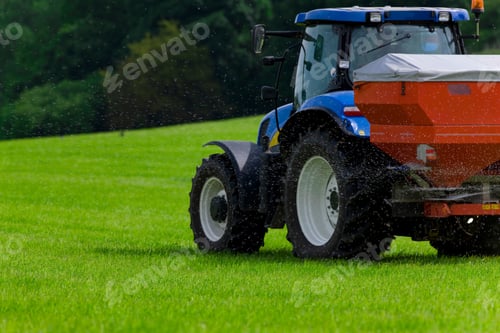 Preview: Tractor Spreading Fertilizer On Crops In Farm Field