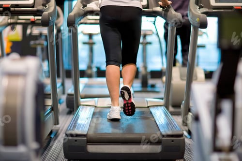 Preview: Detail Of Active Woman Walking On Treadmill In Health Club Gym