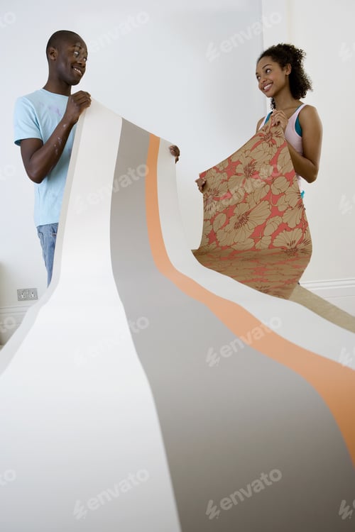 Preview: Young Couple Looking At Wallpaper, Smiling At Each Other