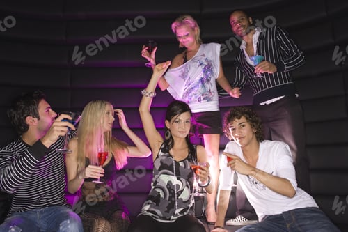 Preview: Young Couple Dancing In A Nightclub With Their Friends Having Drinks
