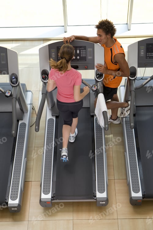 Preview: Fitness Instructor Training Woman On Treadmill In Gym, Elevated View