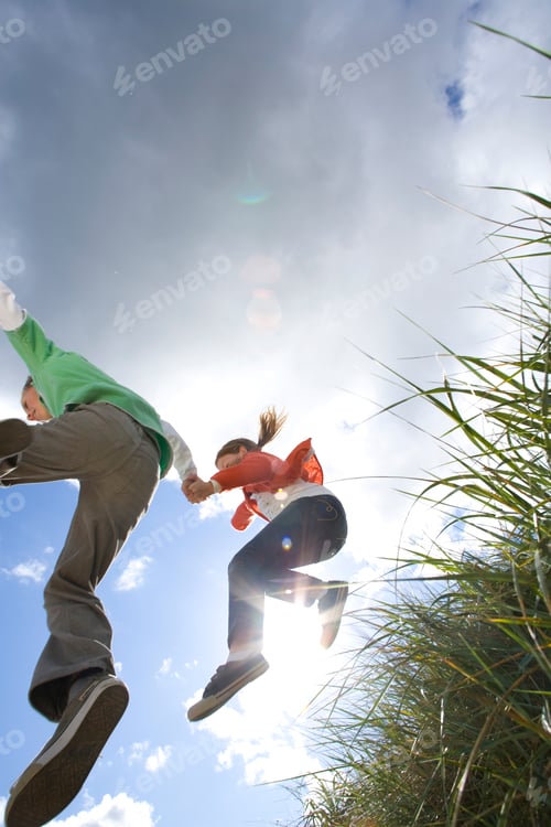 Preview: Active Children Mid-Air Jumping From Grassy Bank