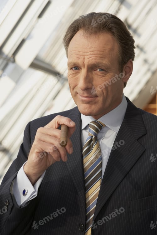 Preview: Close-Up Of A Businessman Holding A Cigar