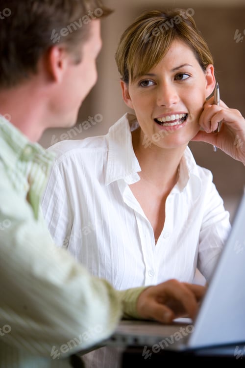 Preview: Businessman And Businesswoman Using Laptop Having Meeting In Office