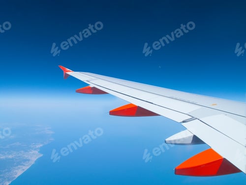 Preview: Travel Concept With Airplane Wing In Flight Over Ocean And Coastline