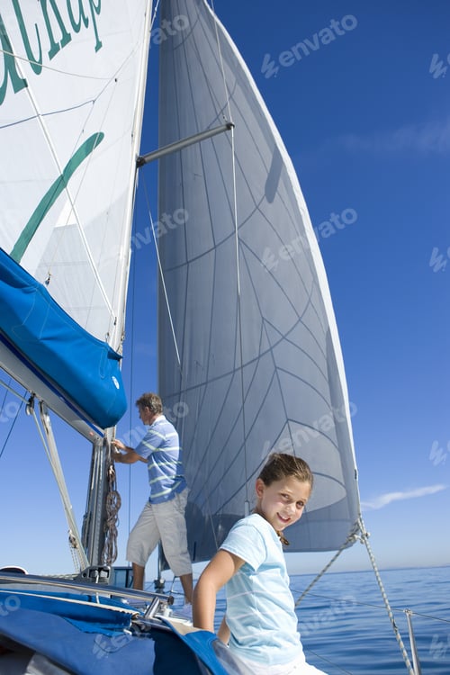 Preview: Father And Daughter (8-10) On Deck Of Sailing Boat, Man Standing Beside Sails, Focus On Girl In