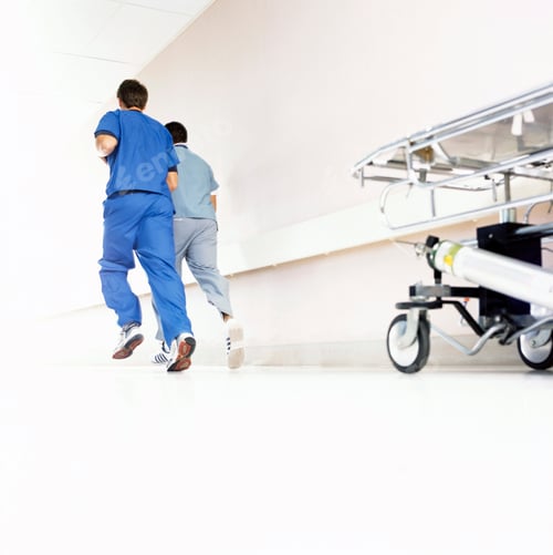 Preview: Emergency Doctors In Scrubs Running Along Hospital Corridor