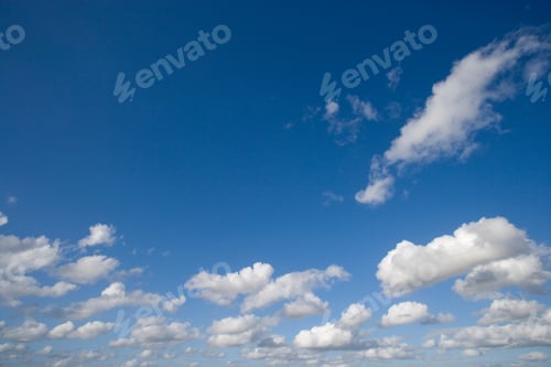Preview: White Fluffy Cumulus Clouds Against Blue Summer Sky