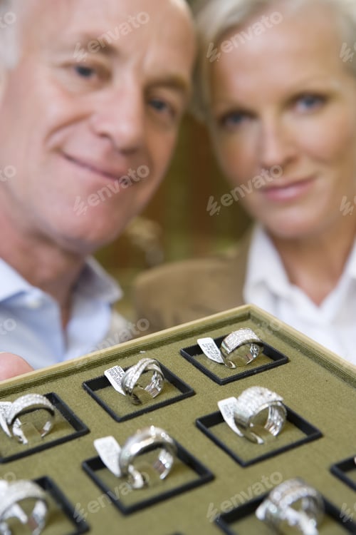 Preview: Mature Male And Female Jewellery Shop Assistants With Tray Of Rings, Smiling, Portrait