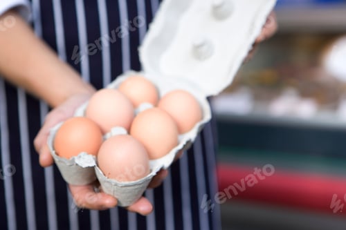 Preview: Woman Working In Food Store With Open Box Of Fresh Eggs