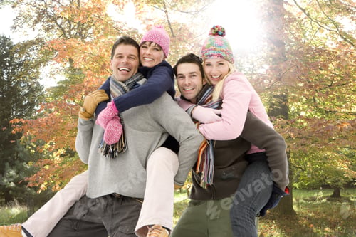 Preview: Portrait Of Men Piggybacking Women In Park