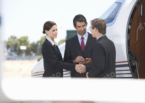 Preview: Three Business Colleagues Standing By A Plane