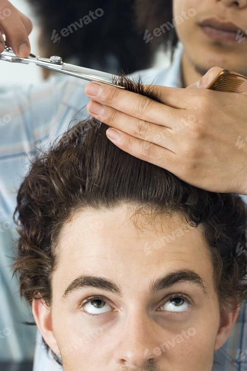 Preview: Hairdresser Cutting Man'S Hair In Barbers Shop, Looking Up, Front View, Close-Up