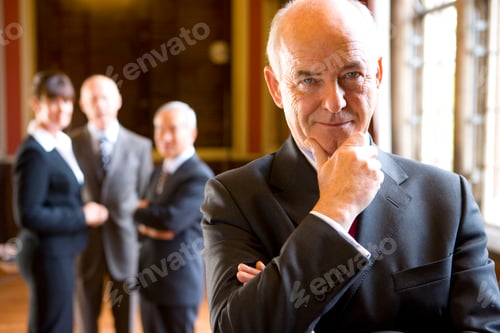 Preview: Portrait Of Mature Businessman Smiling In Old Fashion Office Room