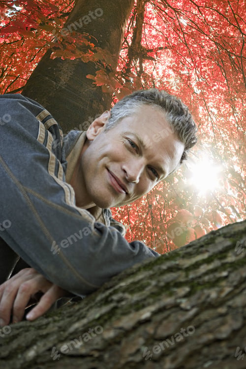 Preview: Man Leaning On Tree In Autumn