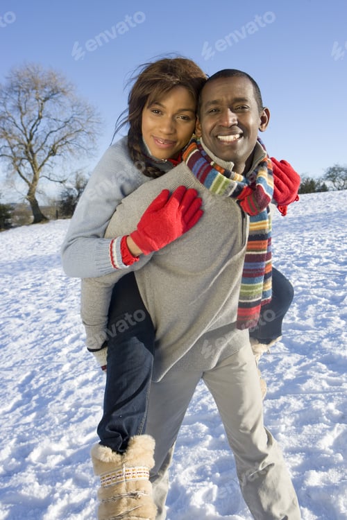 Preview: Husband Giving Wife Piggyback Ride In Snowy Field