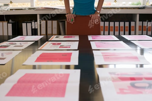 Preview: Businesswoman Choosing Between Working Design Options On Office Table