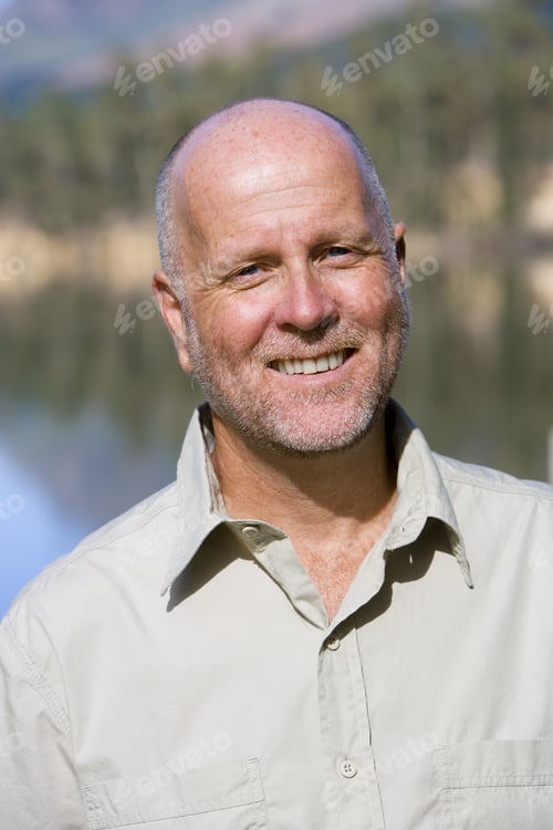 Preview: Mature Man Standing Beside Lake, Smiling, Close-Up, Front View, Portrait