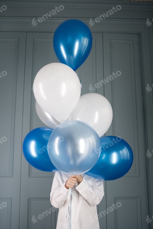 Preview: Boy Hiding Behind A Bunch Of Balloons