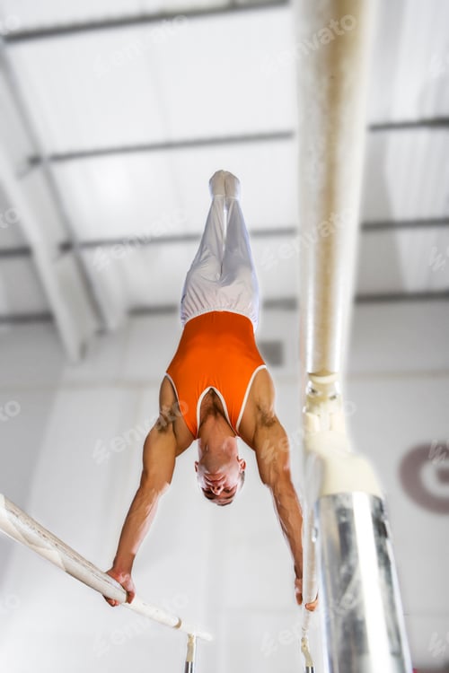 Preview: Male Gymnast Balancing On Parallel Bars From Below