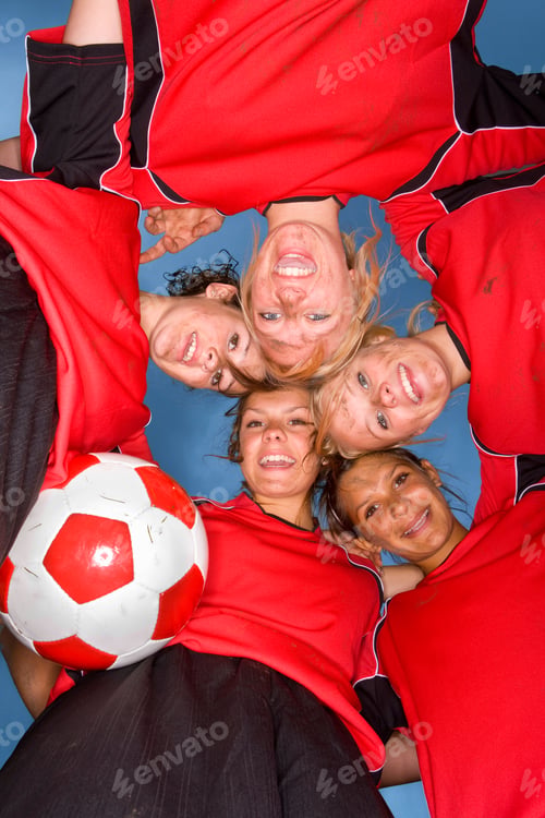 Preview: Smiling Teenage Girls In Soccer Team Uniforms In Huddle At Camera