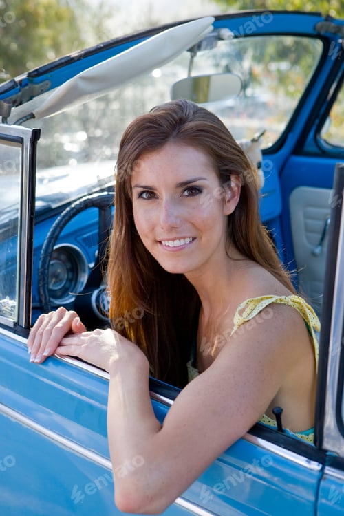 Preview: Portrait Of Smiling Woman Driving Classic Convertible Car