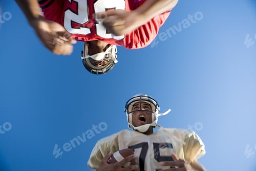 Preview: American Football Player Running With Ball At Opposing Player During Competitive Game, Upward View
