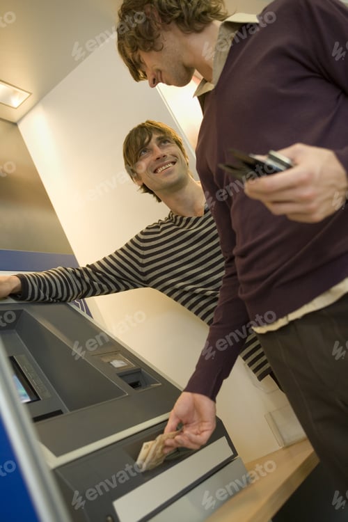 Preview: Two Men At An Atm Machine.