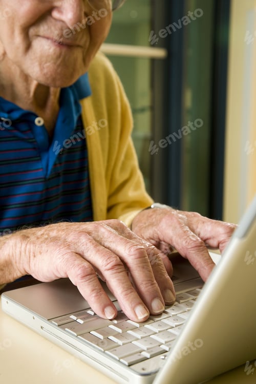 Preview: An Elderly Man Using A Laptop