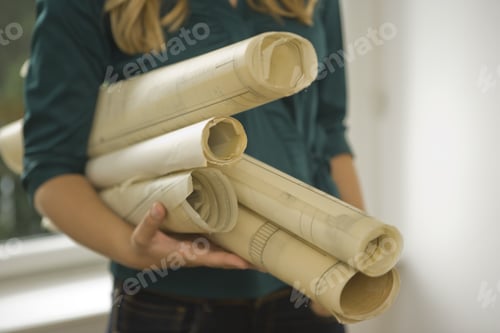 Preview: Mid Section View Of A Female Architect Holding Blueprints