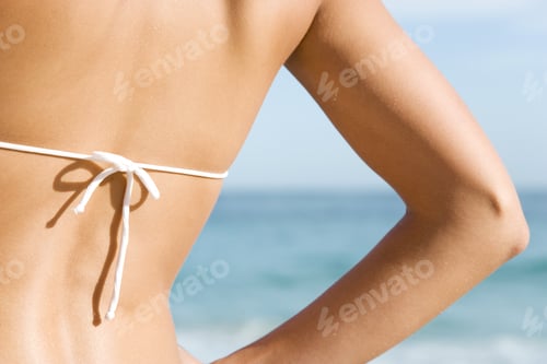 Preview: A Young Woman On The Beach Rear View