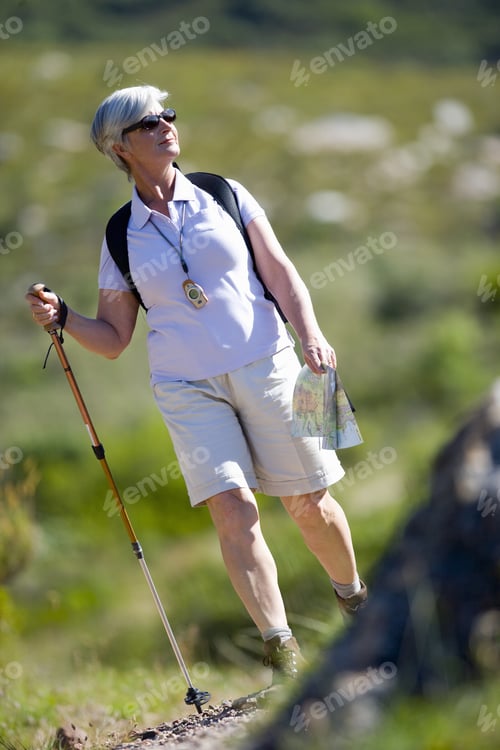 Preview: Woman Hiking With Walking Stick And Map