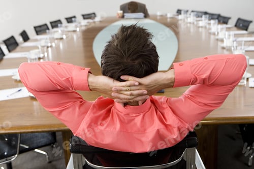 Preview: Businessman Sitting At Conference Table