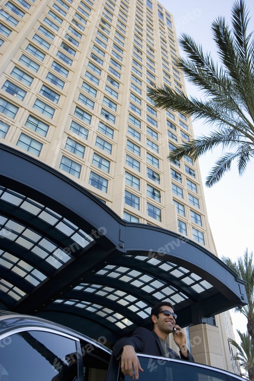 Preview: Businessman Talking On Cell Phone In Urban Setting